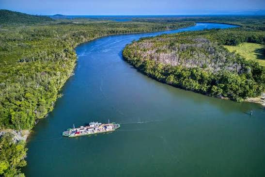 Aerial view of a tropical Far North Queensland river winding through rainforest